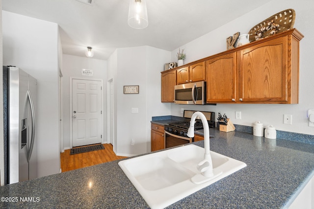 9119 W Arden Ln, Bellemont, AZ 86015 - kitchen featuring stainless steel appliances, brown cabinetry, and dark countertops