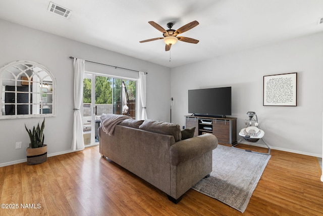 9119 W Arden Ln, Bellemont, AZ 86015 - living room with visible vents, baseboards, a ceiling fan, and wood finished floors