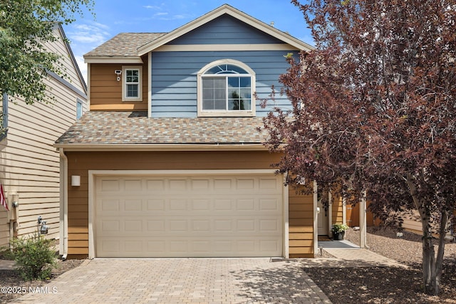9119 W Arden Ln, Bellemont, AZ 86015 - traditional-style home featuring a garage, roof with shingles, and decorative driveway