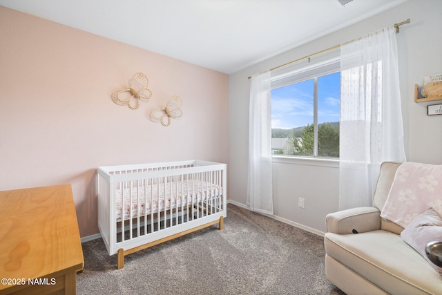 9119 W Arden Ln, Bellemont, AZ 86015 - bedroom featuring a nursery area, baseboards, and carpet flooring