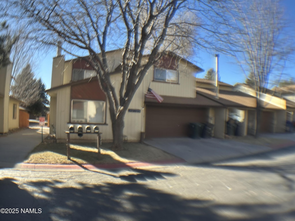 rear view of house with a garage