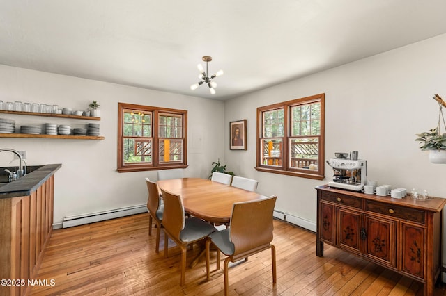 3480 S Moore Cir, Flagstaff, AZ 86005 - dining area with baseboard heating, light wood-style floors, and a chandelier