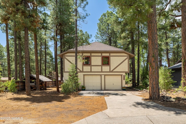 3480 S Moore Cir, Flagstaff, AZ 86005 - view of front of house featuring stucco siding, driveway, and a garage