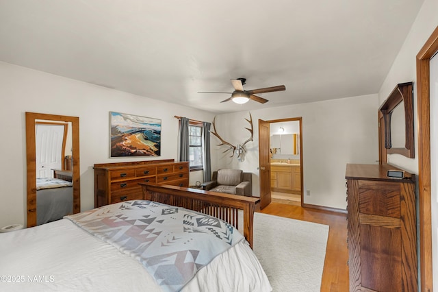 3480 S Moore Cir, Flagstaff, AZ 86005 - bedroom with wood finished floors, connected bathroom, and a ceiling fan