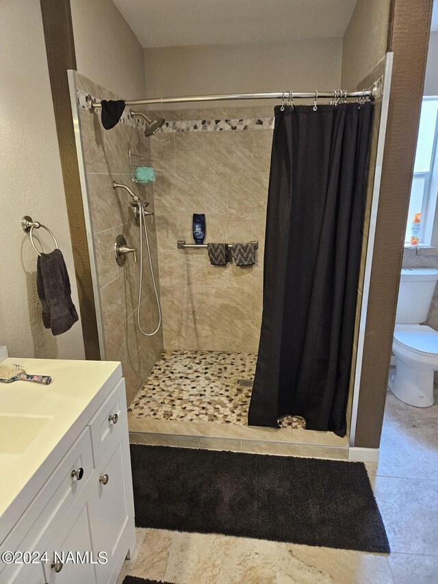 bathroom featuring a shower with curtain, toilet, tile patterned flooring, and vanity