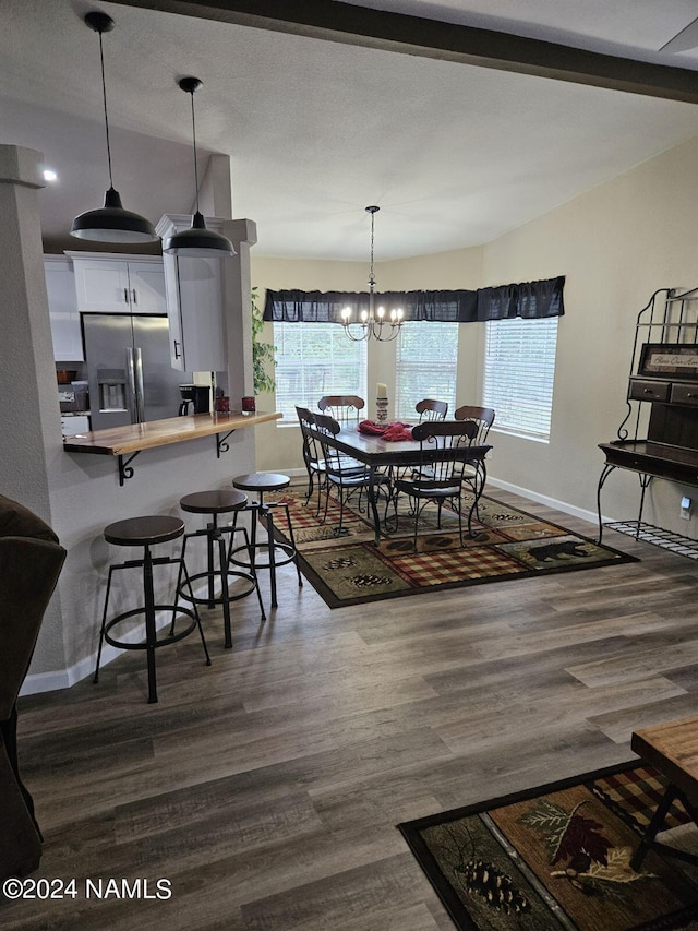 dining space with a notable chandelier and dark hardwood / wood-style flooring