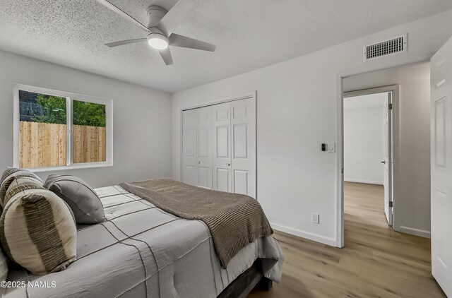 4972 E Snow Shoe Way, Flagstaff, AZ 86004 - bedroom featuring wood finished floors, a closet, baseboards, and a ceiling fan