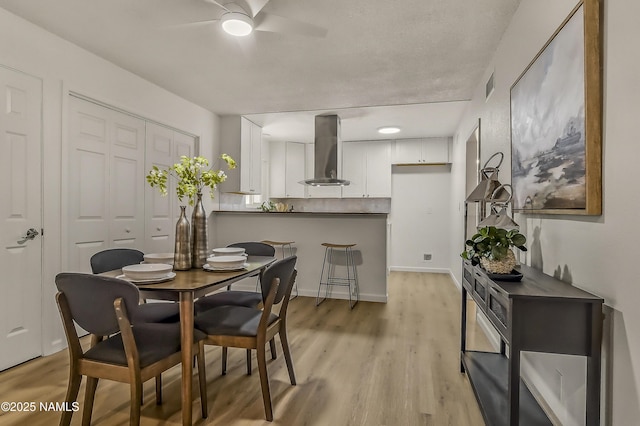 4972 E Snow Shoe Way, Flagstaff, AZ 86004 - dining room with ceiling fan, light wood finished floors, and baseboards
