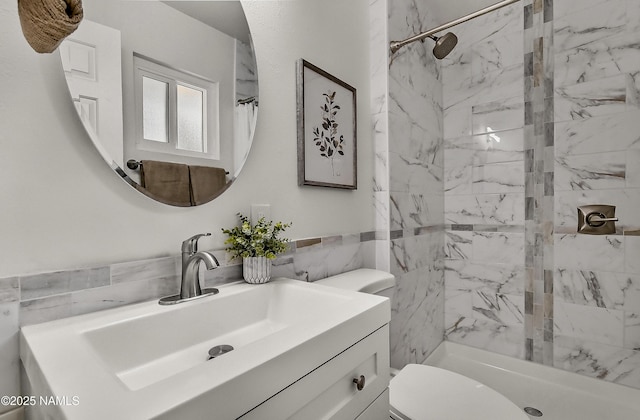4972 E Snow Shoe Way, Flagstaff, AZ 86004 - full bath with a marble finish shower, tile walls, vanity, toilet, and a wainscoted wall