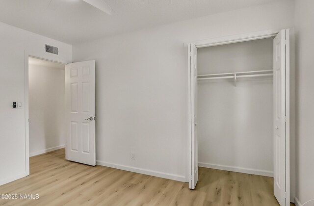 4972 E Snow Shoe Way, Flagstaff, AZ 86004 - unfurnished bedroom featuring wood finished floors, a closet, and baseboards
