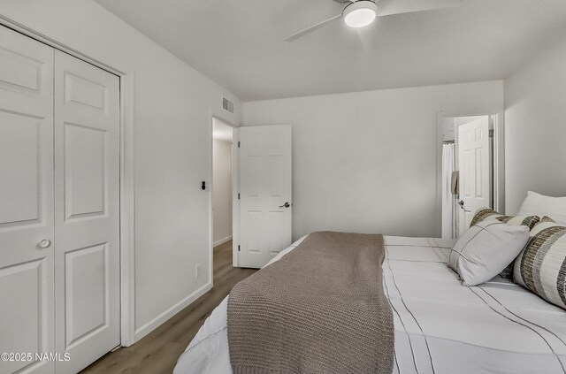 4972 E Snow Shoe Way, Flagstaff, AZ 86004 - bedroom featuring wood finished floors, a closet, a ceiling fan, and baseboards