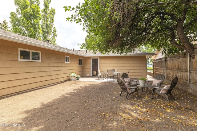 4972 E Snow Shoe Way, Flagstaff, AZ 86004 - back of property featuring a patio, a shingled roof, and outdoor dining area