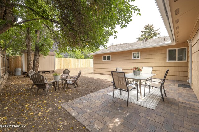 4972 E Snow Shoe Way, Flagstaff, AZ 86004 - fenced backyard with outdoor dining area and a patio