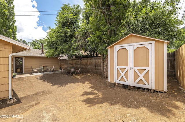 4972 E Snow Shoe Way, Flagstaff, AZ 86004 - view of shed featuring a fenced backyard and outdoor dining space