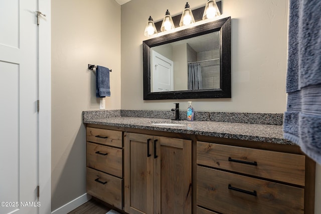 bathroom featuring vanity and curtained shower