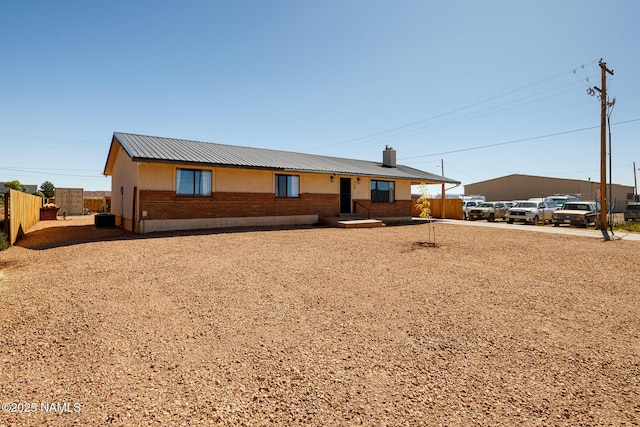 ranch-style home with central AC unit