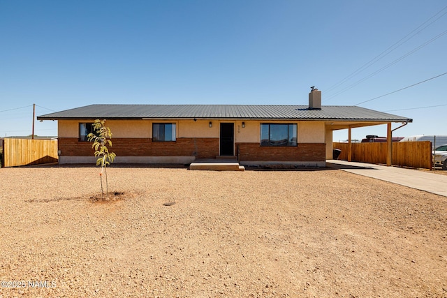 ranch-style house featuring a carport