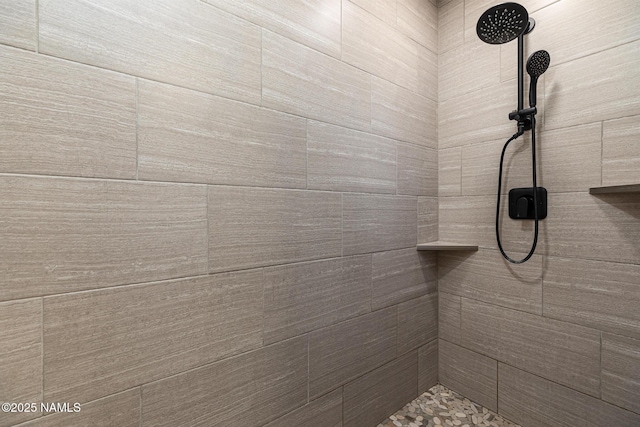 bathroom with tiled shower