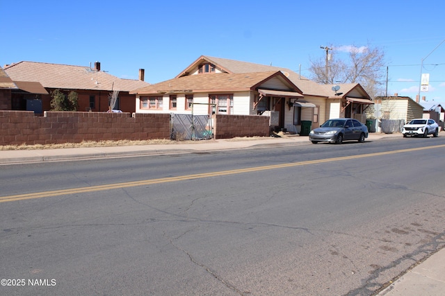 single story home featuring a fenced front yard