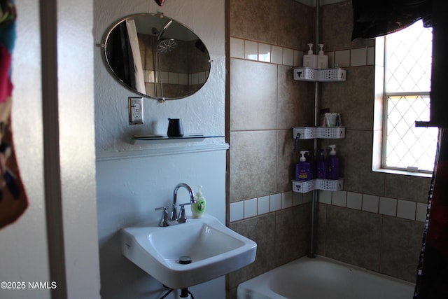 full bath featuring a bathtub and a sink