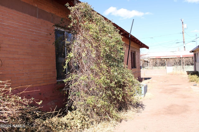 view of side of home with brick siding