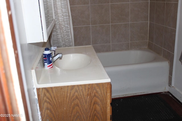 full bath featuring vanity and a washtub