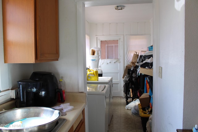 laundry area with tile patterned flooring, cabinet space, and washing machine and dryer