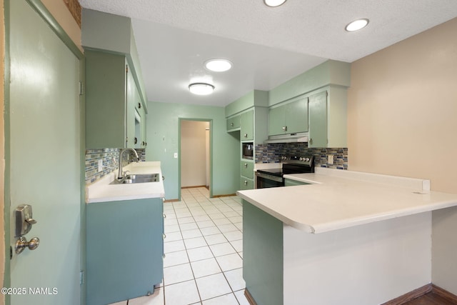 1707 N Fort Valley Rd, Flagstaff, AZ 86001 - kitchen featuring a peninsula, under cabinet range hood, a sink, electric stove, and green cabinetry