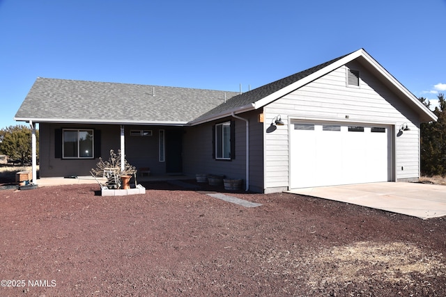 single story home with roof with shingles, driveway, and an attached garage