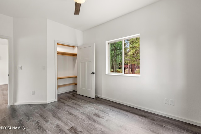 unfurnished bedroom featuring a closet, ceiling fan, and wood-type flooring