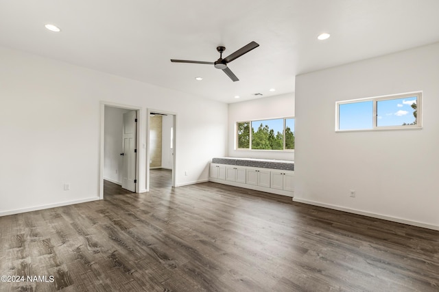 interior space with ceiling fan and dark hardwood / wood-style floors