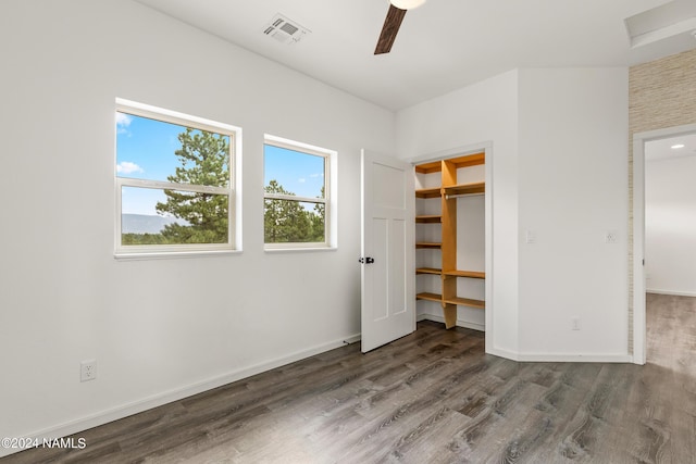 unfurnished bedroom featuring hardwood / wood-style floors, a closet, and ceiling fan