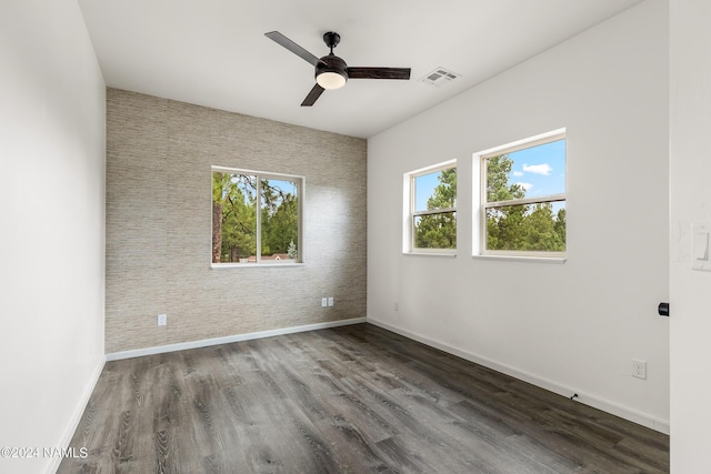 unfurnished room with ceiling fan and dark hardwood / wood-style floors