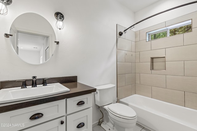 full bathroom featuring toilet, tiled shower / bath, and vanity