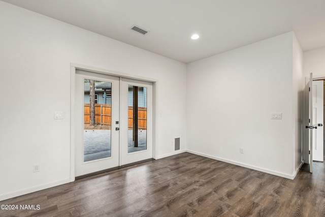 unfurnished room featuring dark hardwood / wood-style flooring and french doors