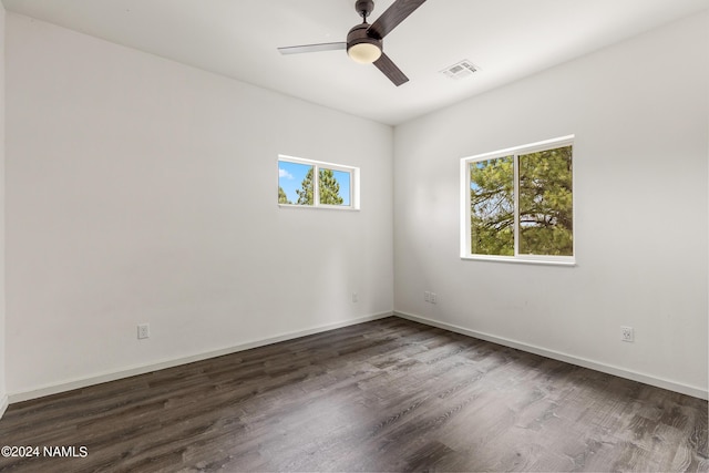 spare room featuring dark wood-type flooring and ceiling fan