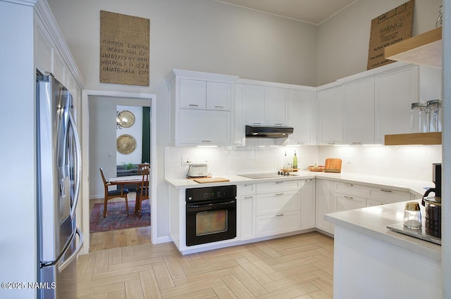 1750 E Mallory St, Mesa, AZ 85203 - kitchen with black appliances, under cabinet range hood, white cabinetry, and tasteful backsplash