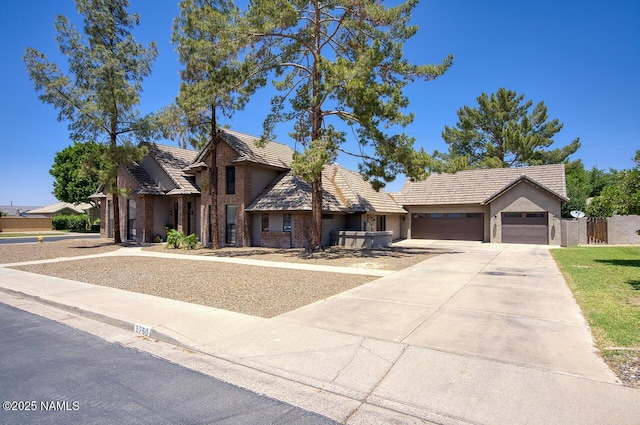 1750 E Mallory St, Mesa, AZ 85203 - view of front facade featuring a garage, driveway, a tiled roof, and stucco siding