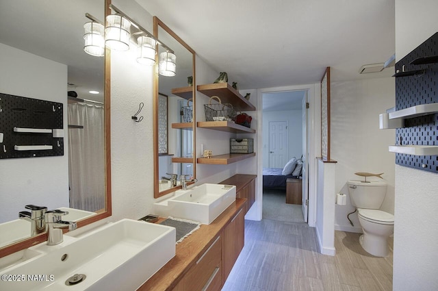 1750 E Mallory St, Mesa, AZ 85203 - bathroom with double vanity, wood finished floors, and connected bathroom