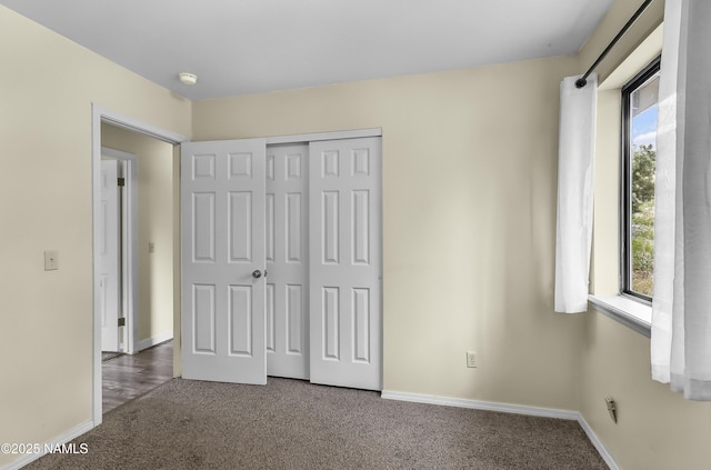4316 E Broken Rock Loop, Flagstaff, AZ 86004 - unfurnished bedroom featuring carpet, multiple windows, a closet, and baseboards