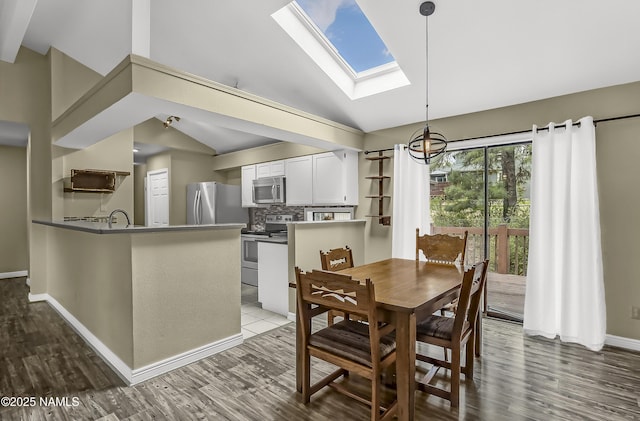 4316 E Broken Rock Loop, Flagstaff, AZ 86004 - dining area with a skylight, dark wood finished floors, baseboards, and high vaulted ceiling
