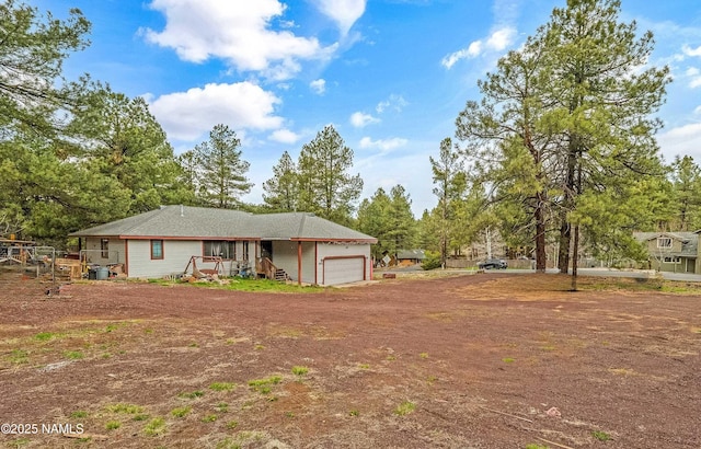 3366 Toho Trl, Flagstaff, AZ 86005 - back of house featuring a garage and driveway