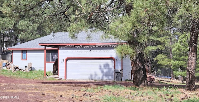 3366 Toho Trl, Flagstaff, AZ 86005 - view of front facade with a trampoline, roof with shingles, and a garage