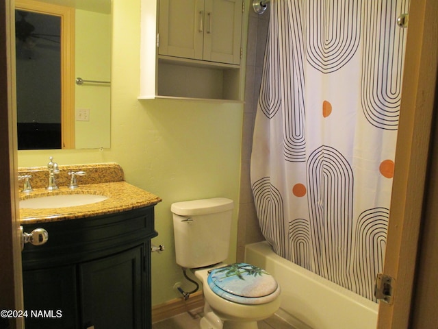 full bathroom featuring shower / bath combo with shower curtain, toilet, and vanity