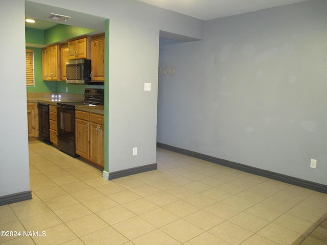 kitchen with black appliances and light tile patterned flooring