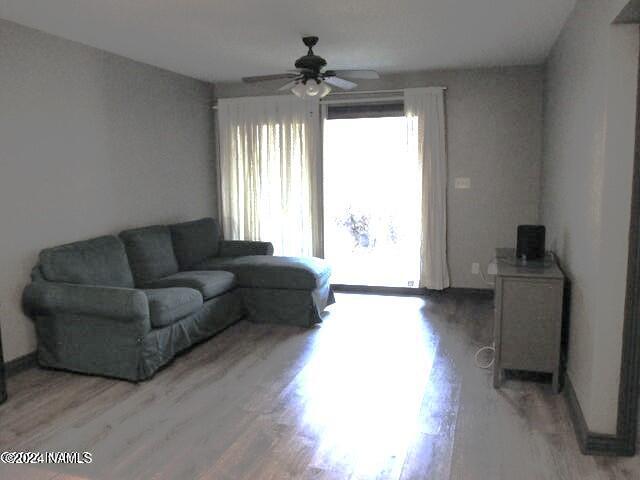 living room with hardwood / wood-style flooring and ceiling fan