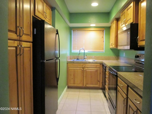 kitchen featuring sink, light tile patterned floors, and black appliances