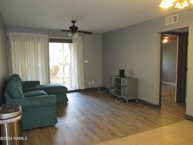 living room with wood-type flooring and ceiling fan