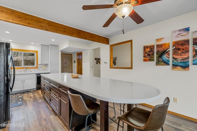 2466 N Earle Dr, Flagstaff, AZ 86004 - kitchen with freestanding refrigerator, dark wood-style flooring, backsplash, light countertops, and beamed ceiling