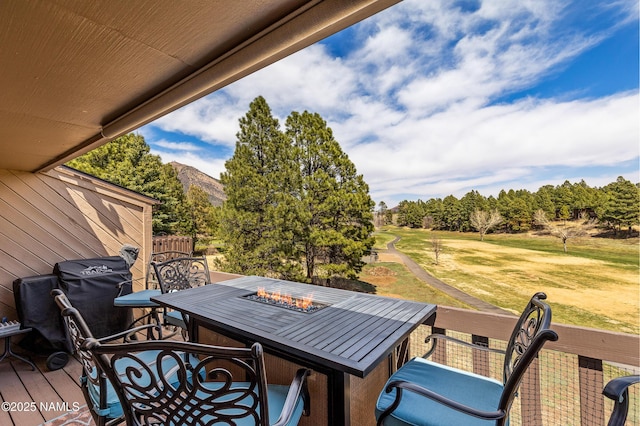 2466 N Earle Dr, Flagstaff, AZ 86004 - view of patio / terrace featuring a grill, view of scattered trees, outdoor dining space, and an outdoor fire pit
